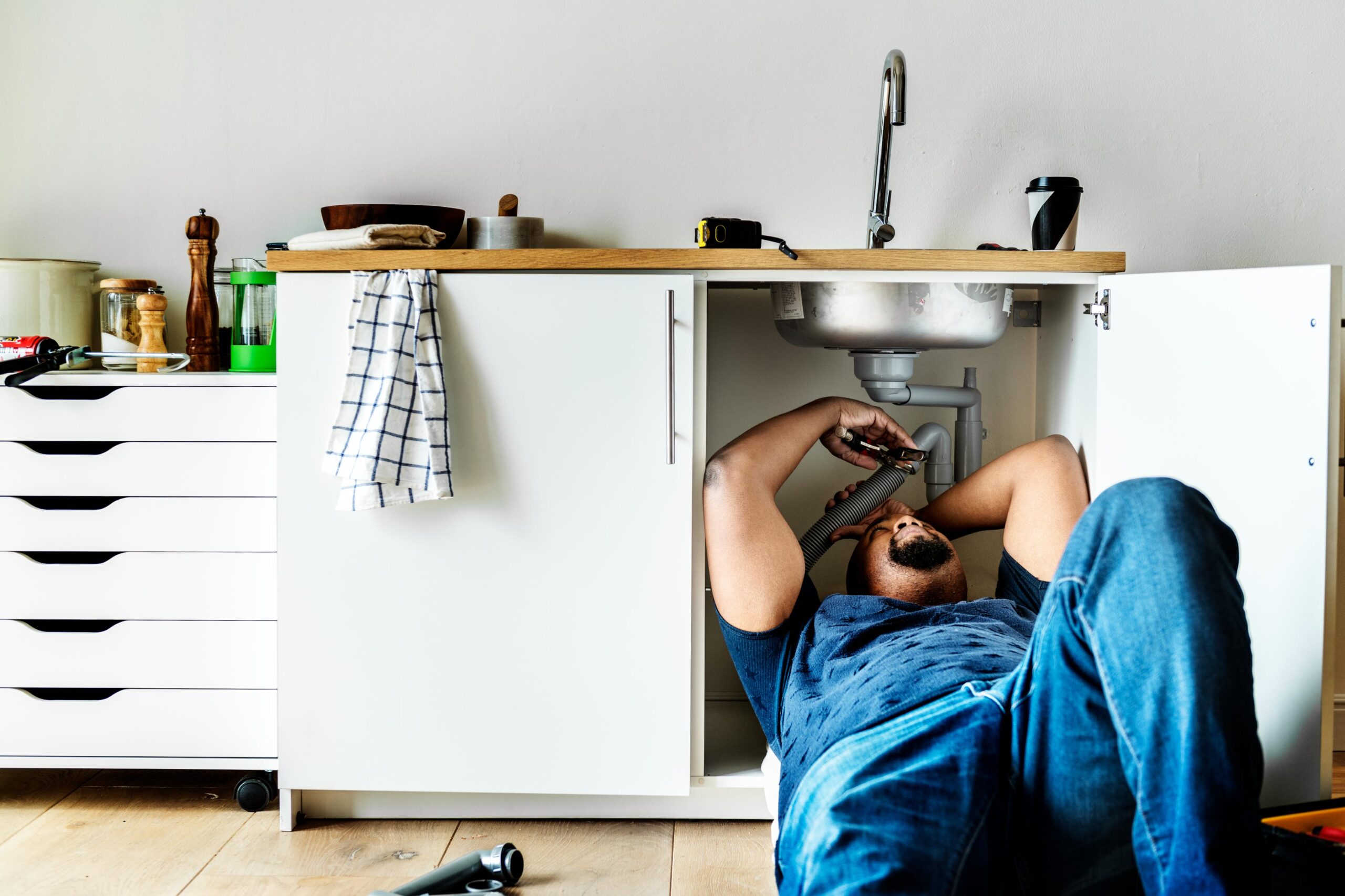A plumber fixing a blocked drain